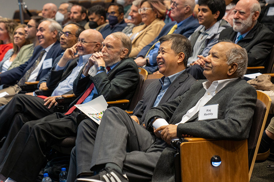  People sit in an auditorium during an event.