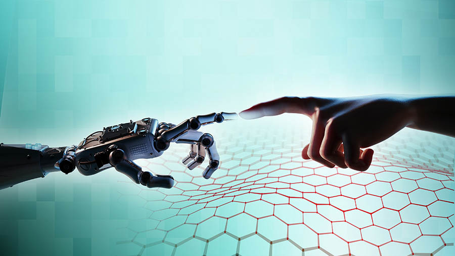  A robot hand on the left reaches out to touch a human hand on the right.